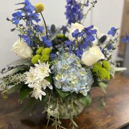 Blue and white floral arrangement in a glass vase