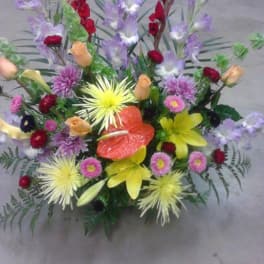 Colorful mixed flower arrangement with lilies, roses, and chrysanthemums