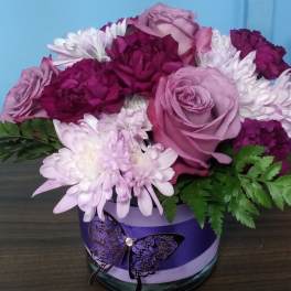 Lavender roses and white chrysanthemums in a purple vase