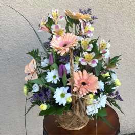 Mixed bouquet with gerbera daisies, daisies, and alstroemeria in a basket