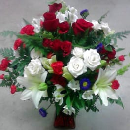 Bouquet of red and white roses with white lilies in a vase