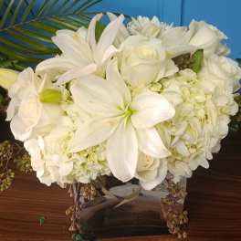 White floral arrangement in a clear glass vase