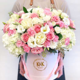 Large bouquet of pink and white roses in a white hat box