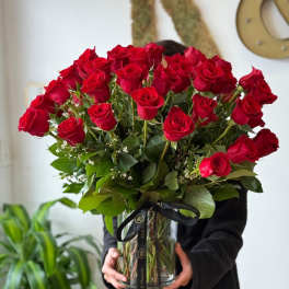 Large bouquet of red roses in a clear glass vase
