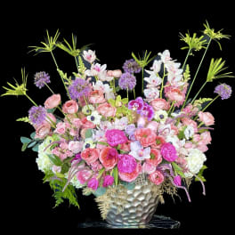 Pink and white mixed flower arrangement in a silver vase