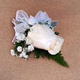 White rose boutonniere with baby's breath and silver ribbon