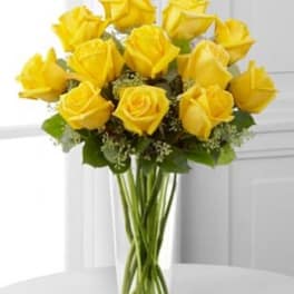 Yellow roses arranged in a clear glass vase