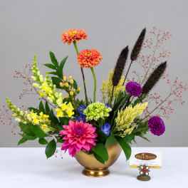 Colorful mixed flower arrangement in a gold bowl vase