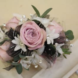 Pink rose bouquet with white flowers and black ribbon accents