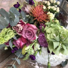 Mixed bouquet with pink roses, green hydrangea, and purple flowers