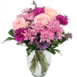 Pink and purple bouquet in a clear glass vase