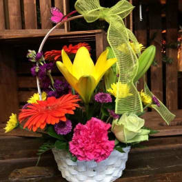 Colorful flower basket with lilies, gerbera daisies, carnations, and roses