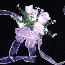 Small bouquet of pale pink roses with a lavender ribbon bow