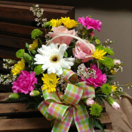 Mixed flower basket with pink roses, white gerbera daisy, and bright ribbon
