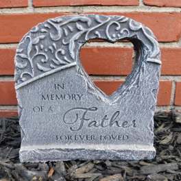 Stone memorial plaque reading "In Memory of a Father Forever Loved"