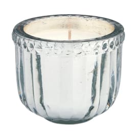 Clear glass candle holder with a white candle inside