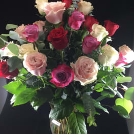 Bouquet of red, pink, and white roses in a glass vase