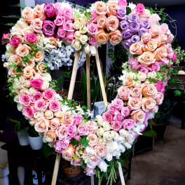 Heart-shaped rose wreath on a wooden easel