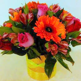 Bouquet of orange and pink flowers in a yellow vase