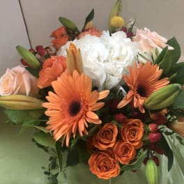 Bouquet of orange and white flowers with pale pink roses