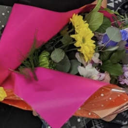 Mixed bouquet wrapped in bright pink and orange paper