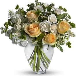 Bouquet of cream and white roses in a clear glass vase