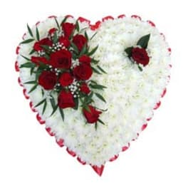 Heart-shaped floral arrangement with red roses and white flowers
