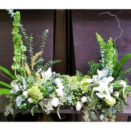 White and green floral arrangement with tall upright blooms