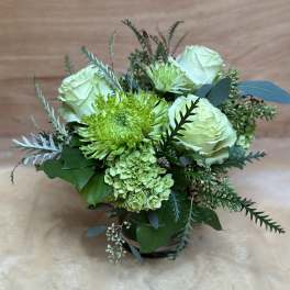 Green and white bouquet with roses and chrysanthemums in a vase