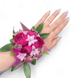 Pink rose wrist corsage with ribbon and greenery