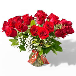 Bouquet of red roses in a glass vase with baby's breath