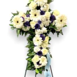 White and purple floral standing cross on an easel