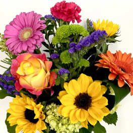 Colorful bouquet with sunflowers, gerbera daisies, a rose, and carnations