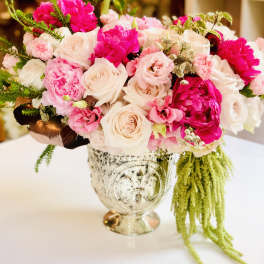 Pink and white rose bouquet in an ornate silver vase