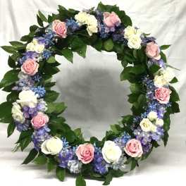 Circular floral wreath with pink and white roses and purple flowers