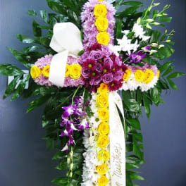 Cross-shaped floral arrangement with yellow, purple, and white flowers