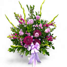 Lavender and pink mixed bouquet with a ribbon in a vase