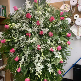Large standing spray of pink roses and white orchids