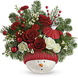 Christmas bouquet in a snowman container with red and white roses