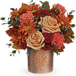 Autumn bouquet of roses and mums in a bronze vase