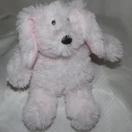 Pink plush dog toy with floppy ears and black nose