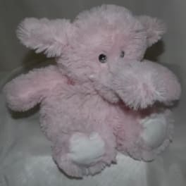 Pink plush teddy bear with white paws and black eyes