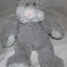 Gray plush bunny with white paws and a pink nose
