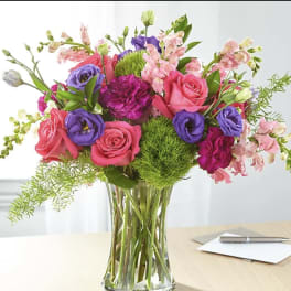 Mixed pink and purple bouquet in a clear glass vase