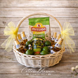 Gift basket with tortilla rounds, mini bottles, limes, and a jar of jalapeño peppers