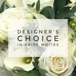 White roses and calla lilies with dark green foliage