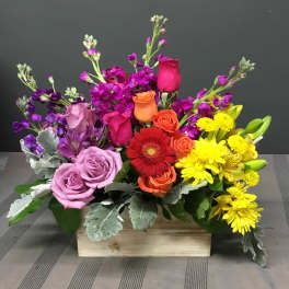 Colorful mixed flower arrangement in a wooden box