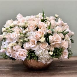 Blush rose arrangement in a copper bowl vase