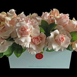 Arrangement of pale pink roses in a light blue box