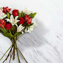 Bouquet of red roses, white lilies, and white daisies